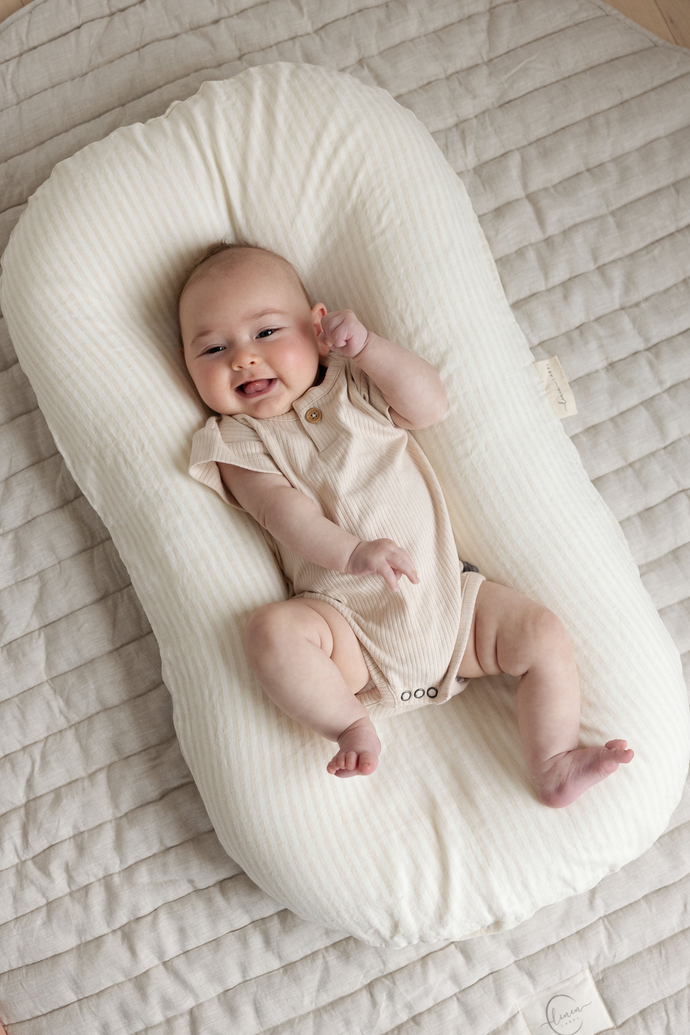 Linen Label baby lounger featuring the baby pink pure linen flax cover