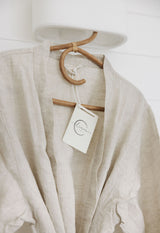 Linen Label bathrobe hanging in the bathroom looking elegant and soft showing off the pure natural colour of french Linen