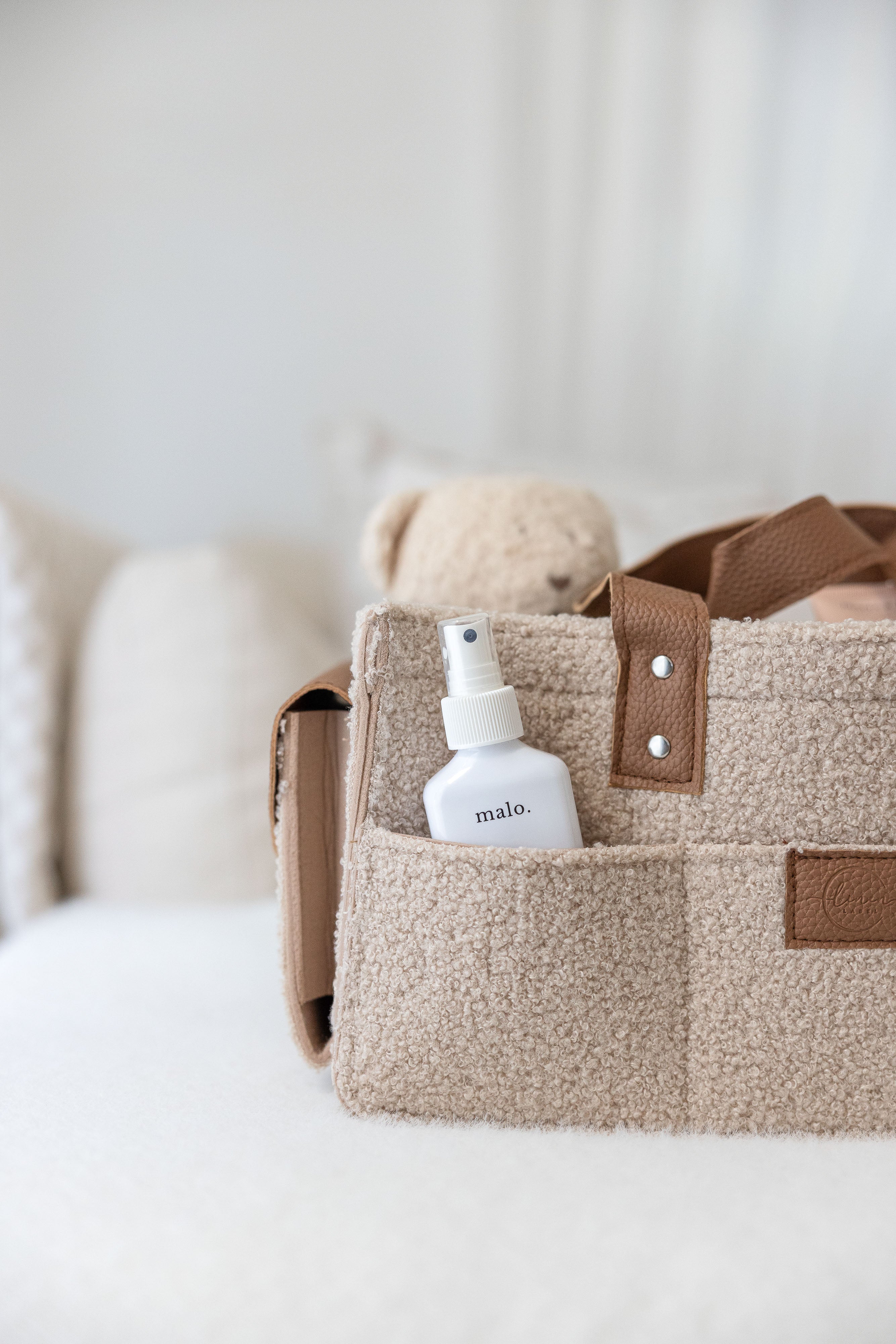 linen label caddy in dark nude colour soft teddy like outer fabric. showing detail of all functioning pockets