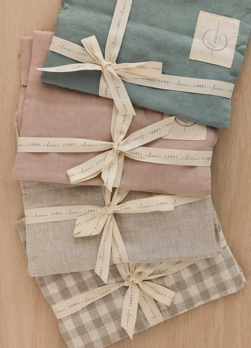 four Linen Label pure Linen colours available in the lounger nest. duck egg blue, Dusty Rose pink, Natural oat, Natural gingham