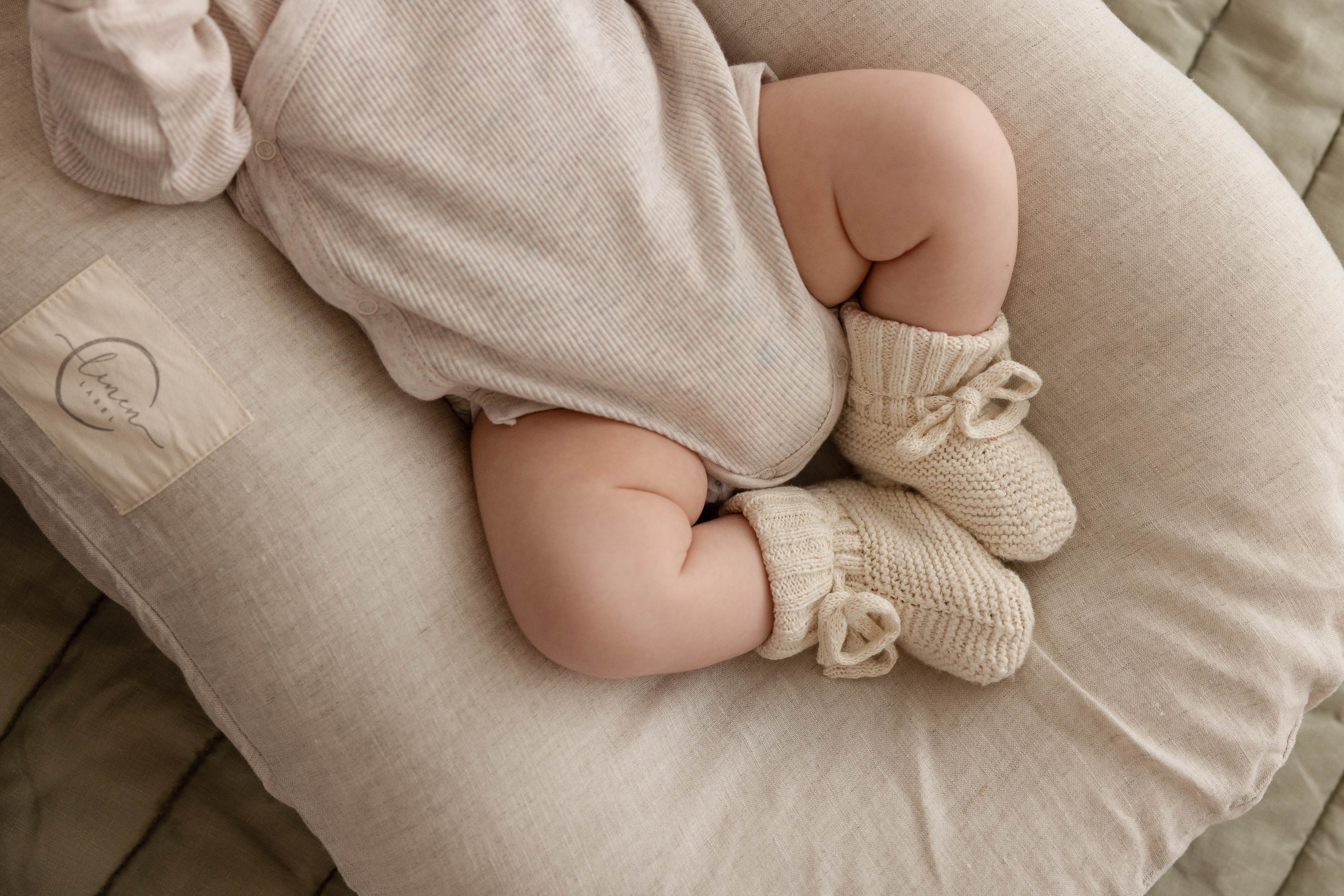 Linen Label cute little baby on back longer.Specially designed baby nest with a cushioned end for tummy time and a level surface for play, featuring a central sling for sensory experiences