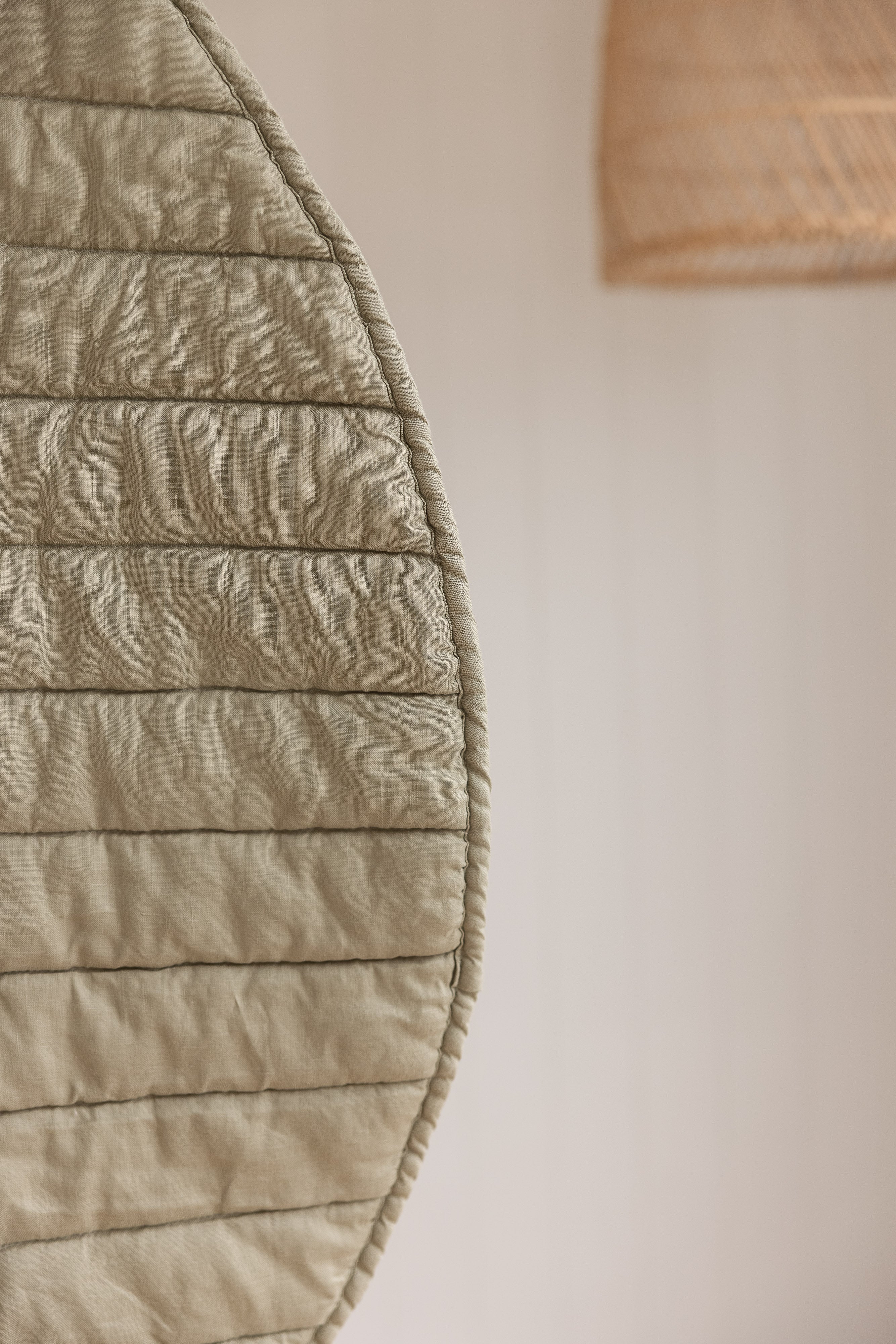 close-up photo showing the play mat showing close-up photo of  the detail and high quality of the mat as well as the soft sage green colour