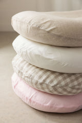 pilled on top of each other all four new baby loungers colours by linen label, natural Oat, white snow, gingham beige, Baby Pink