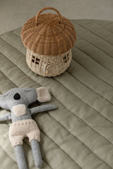 cane toy basket and koala toy on Linen Label Pure French Linen quilted padded play mat in Soft Sage green