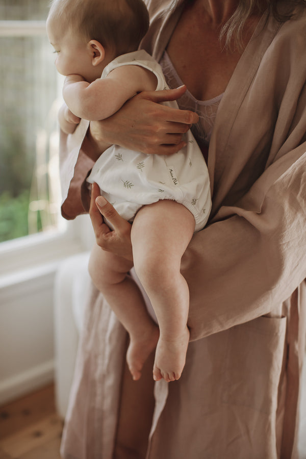 Mother dressed in Linen Dusty Rose Pink French Linen Bathrobe Kimono Robe holding a newborn baby showing these robes are perfect for easy breastfeeding days around the home - looking luxurious and aesthetically pleasing in a sage green, perfect for ultimate comfort and relaxation. Crafted with 100% French Linen that grows softer with each wash. 